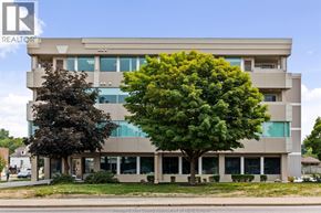 Windsor apartment for rent - A large building with a tree in front of it.