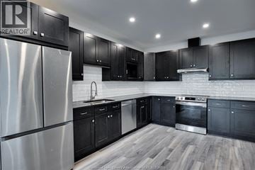 Windsor apartment for rent - A kitchen with black cabinets and a stainless steel refrigerator.