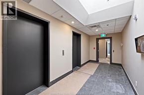 Windsor apartment for rent - A hallway with a black door on the left and a wooden door on the right.