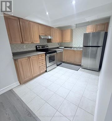 Vaughan (Maple) apartment for rent - A kitchen with wooden cabinets and a stainless steel refrigerator.