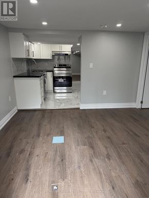 Hamilton (Crown Point) duplex for rent - A kitchen with white cabinets and a black countertop is shown.