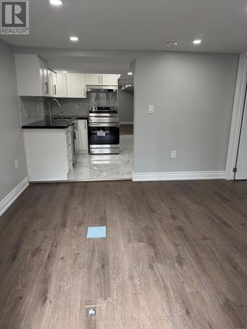 Hamilton (Crown Point) duplex for rent - A kitchen with white cabinets and a black countertop is shown.