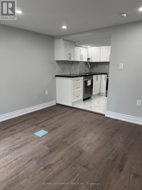 Hamilton (Crown Point) duplex for rent - A kitchen with white cabinets and a wooden floor.