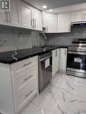 Hamilton (Crown Point) duplex for rent - A kitchen with white cabinets and marble countertops.