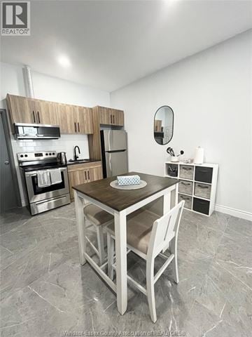 Windsor apartment for rent - A kitchen with a table and chairs in the middle of the room.