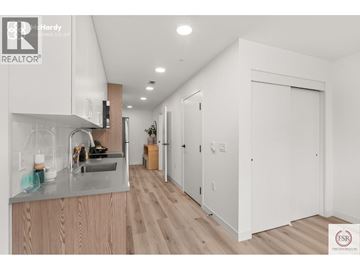 Vancouver apartment for rent - A modern kitchen with wooden cabinets and a stainless steel sink.