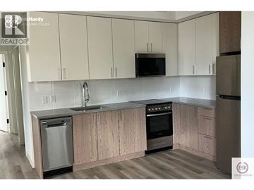 Vancouver apartment for rent - A kitchen with wooden cabinets and stainless steel appliances.