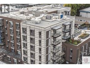 Vancouver apartment for rent - A modern apartment building with a flat roof and balconies.