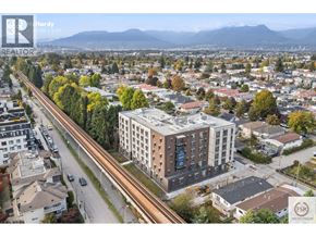 Vancouver apartment for rent - A cityscape with a highway running through it and a large building in the foreground.