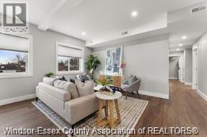 Essex apartment for rent - A well-lit living room with a couch, a coffee table, and a large window.