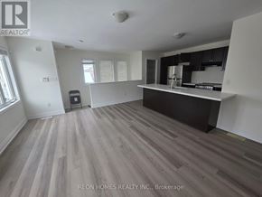 Markham (Cornell) apartment for rent - A spacious kitchen and living room with wood flooring and white walls.