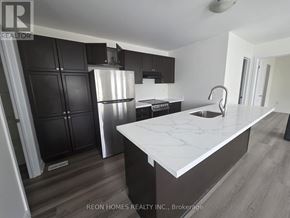 Markham (Cornell) apartment for rent - A kitchen with a white countertop and black cabinets.