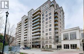 Markham (Commerce Valley) condo for rent - A tall residential building with multiple balconies and a street lamp in front.