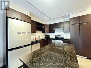 Markham (Commerce Valley) condo for rent - A kitchen with granite countertops and stainless steel appliances.