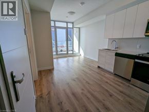 Kitchener condo for rent - A kitchen with a refrigerator, sink, and stove.