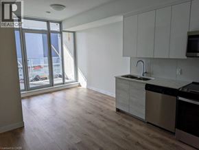 Kitchener condo for rent - A kitchen with a sink, stove, and dishwasher.