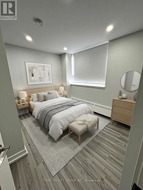 Toronto (Annex) multi-family for rent - A bedroom with a bed, nightstand, and a mirror.