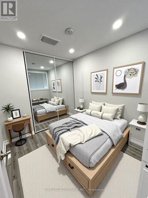 Toronto (Annex) multi-family for rent - A bedroom with a large bed, a mirror, and two nightstands.