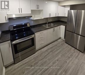 Ajax (Northwest Ajax) apartment for rent - A modern kitchen with stainless steel appliances and white cabinets.