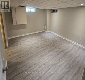 Ajax (Northwest Ajax) apartment for rent - A room with wooden flooring and a door on the left.