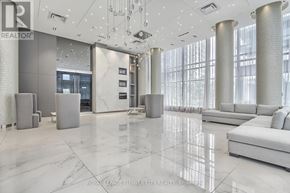 Richmond Hill (Langstaff) condo for rent - A spacious lobby with marble floors and a reception desk.