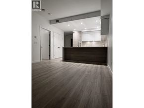 New Westminster apartment for rent - A room with a wooden floor and a counter in the background.