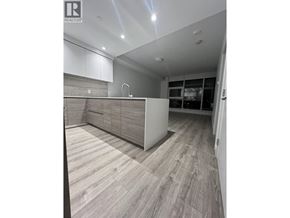 New Westminster apartment for rent - A modern kitchen with wooden flooring and white cabinetry.