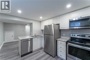 Hamilton apartment for rent - A kitchen with stainless steel appliances and white cabinets.