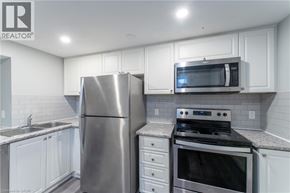 Hamilton apartment for rent - A kitchen with white cabinets and stainless steel appliances.