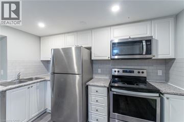 Hamilton apartment for rent - A kitchen with white cabinets and stainless steel appliances.