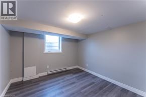 Hamilton apartment for rent - A room with a window and wooden flooring.