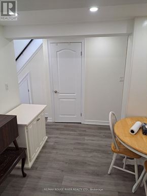 Toronto (Kennedy Park) apartment for rent - A dining room with a wooden table and chairs.