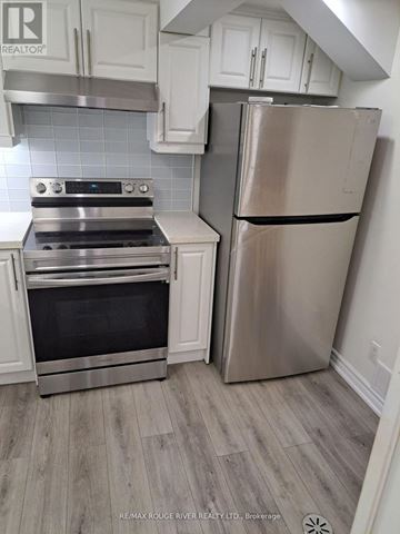 Toronto (Kennedy Park) apartment for rent - A stainless steel refrigerator stands next to a stove in a kitchen.