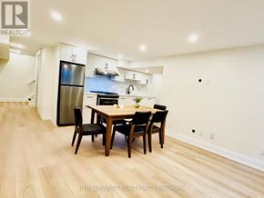 Toronto (Centennial Scarborough) apartment for rent - A dining room with a wooden table and chairs.