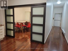 Toronto (Kensington-Chinatown) multi-family for rent - A room with a window and a door.