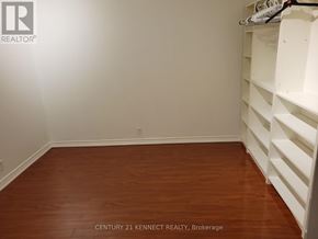Toronto (Kensington-Chinatown) multi-family for rent - A long hallway with wood floors and white walls.