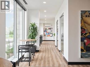 Ottawa apartment for rent - A long hallway with a wooden floor and a painting on the wall.