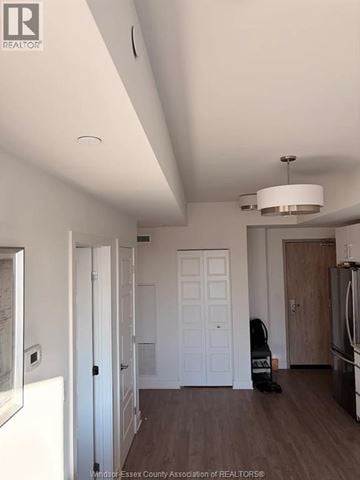 Ottawa apartment for rent - A kitchen with a fridge, a stove and a dining table.