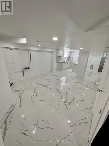Whitby (Williamsburg) apartment for rent - A spacious room with marble flooring and white walls.