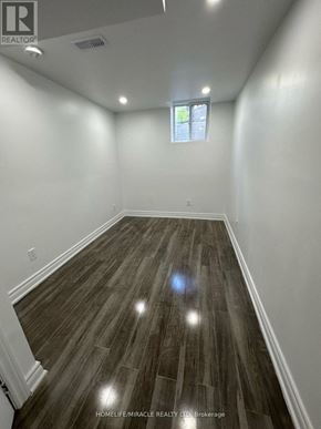 Whitby (Williamsburg) apartment for rent - A room with wooden flooring and a window.