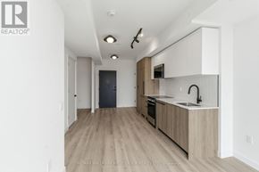 Toronto (Centennial Scarborough) condo for rent - A modern kitchen with wooden floors and cabinets.