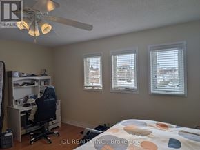 Richmond Hill (Devonsleigh) apartment for rent - A bedroom with a bed, desk, and chair.