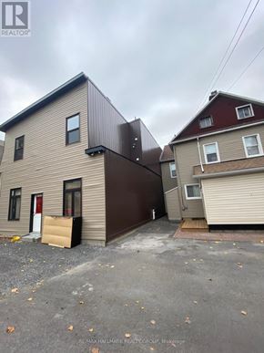 Ottawa townhouse for rent - A house with a brown garage door is for sale.