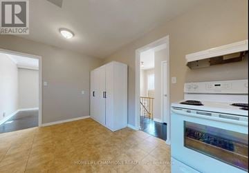 Toronto (Eglinton East) apartment for rent - A kitchen area with a stove top oven and cabinets.