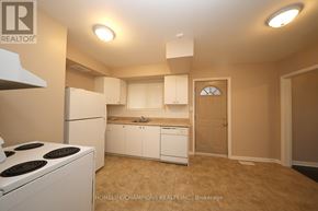 Toronto (Eglinton East) apartment for rent - A small kitchen with white appliances and cabinets.