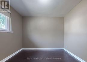 Toronto (Eglinton East) apartment for rent - A room with a window and a brown floor.