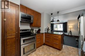Halton Hills (Ac Acton) apartment for rent - A kitchen with wooden cabinets and a black stove top oven.