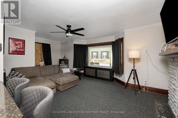 Halton Hills (Ac Acton) apartment for rent - A living room with a grey carpet and a grey couch.