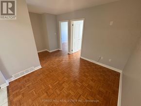 Oakville (Oo Old Oakville) apartment for rent - A room with wooden flooring and a doorway leading to another room.
