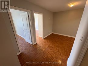 Oakville (Oo Old Oakville) apartment for rent - A room with wooden flooring and white walls.